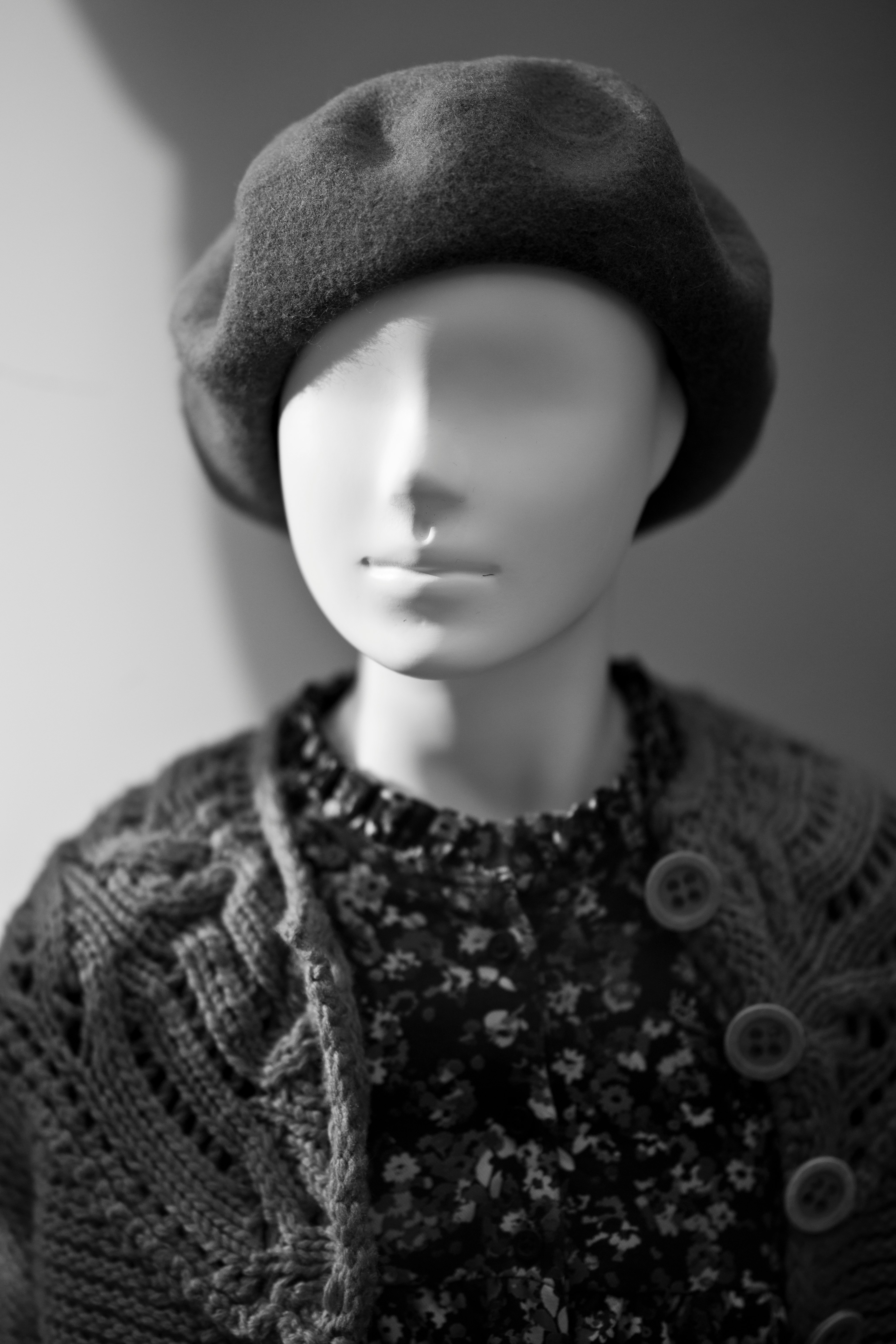 grayscale photo of woman wearing knit cap and knit shirt